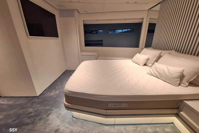 Mabelle Yacht Photos Pics Luxurious bedroom interior of 2022 Arcadia Yachts Sherpa 80 XL with modern design and cozy bedding.