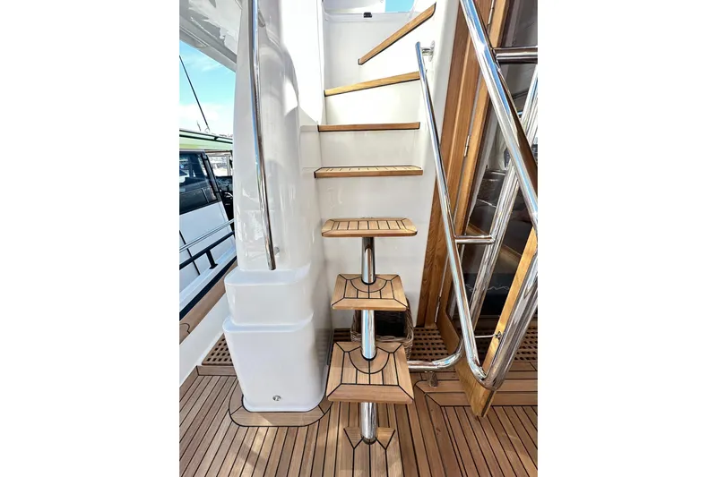  Yacht Photos Pics Staircase on 2026 Sasga Yachts Menorquin 48FB with wooden steps and metal railings.