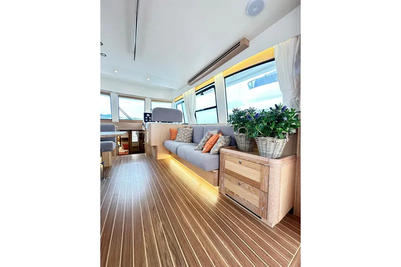  Yacht Photos Pics Luxurious interior of 2026 Sasga Yachts Menorquin 48FB with elegant wood flooring and cozy seating.