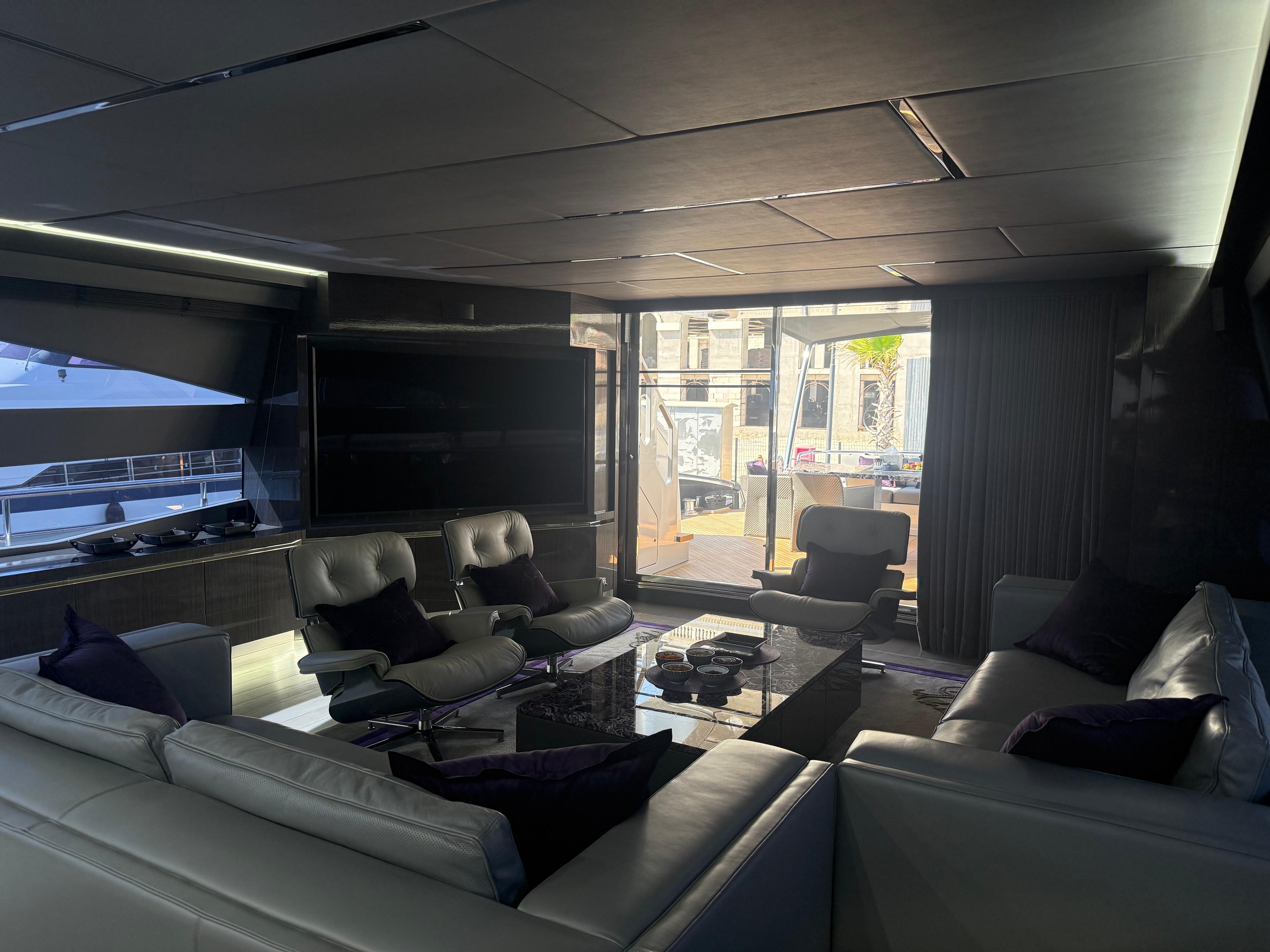 Luxurious yacht interior with modern seating, large TV, and sleek design, AB 100, 2017 model.