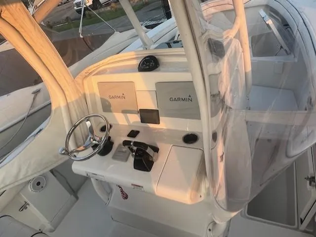  Yacht Photos Pics 2018 Jupiter 29 HFS boat cockpit with Garmin navigation system and steering wheel.