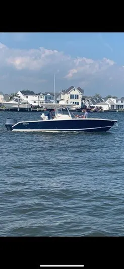  Yacht Photos Pics 2018 Jupiter 29 HFS boat cruising on a sunny day near waterfront homes.