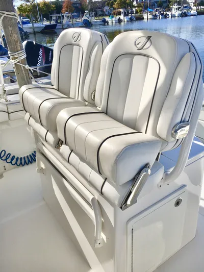  Yacht Photos Pics 2018 Jupiter 29 HFS boat seats with sleek white upholstery, docked by the water.