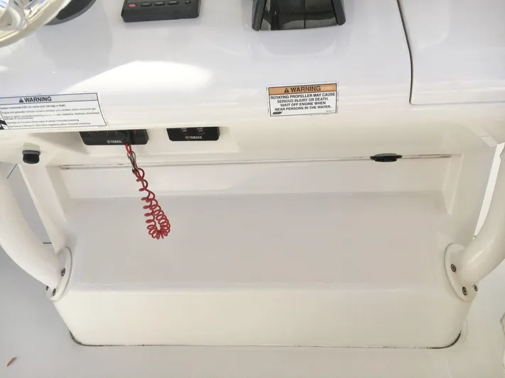  Yacht Photos Pics Control panel of a 2018 Jupiter 29 HFS boat with warning labels and coiled cord.