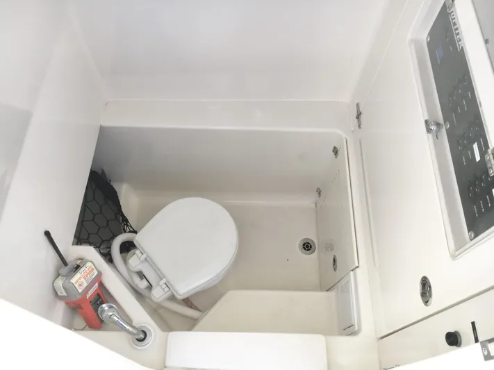  Yacht Photos Pics 2018 Jupiter 29 HFS boat interior with compact marine toilet and control panel.