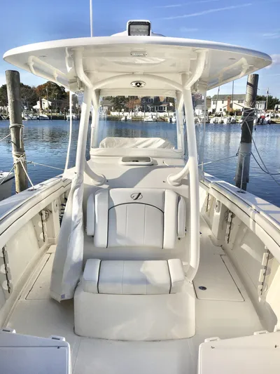  Yacht Photos Pics 2018 Jupiter 29 HFS boat docked in a marina, showcasing sleek design and spacious seating.