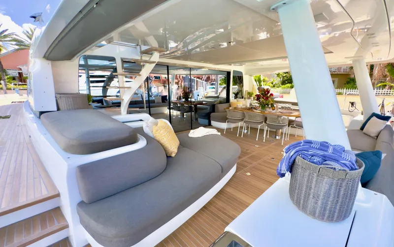 Twin Flame Yacht Photos Pics Luxurious 2020 Lagoon Seventy 7 yacht deck with elegant seating and dining area.