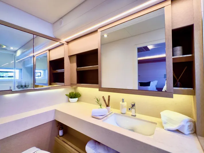 Twin Flame Yacht Photos Pics Luxurious bathroom interior of 2020 Lagoon Seventy 7 yacht with modern fixtures and elegant design.