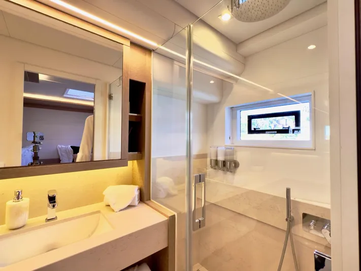 Twin Flame Yacht Photos Pics Luxurious bathroom in 2020 Lagoon Seventy 7 yacht with modern fixtures and glass shower.