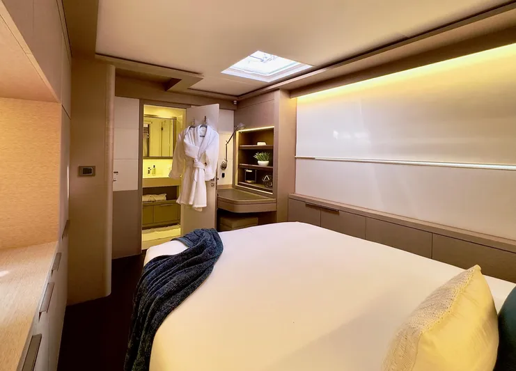 Twin Flame Yacht Photos Pics Luxurious cabin interior of 2020 Lagoon Seventy 7 yacht with modern amenities and cozy bedding.