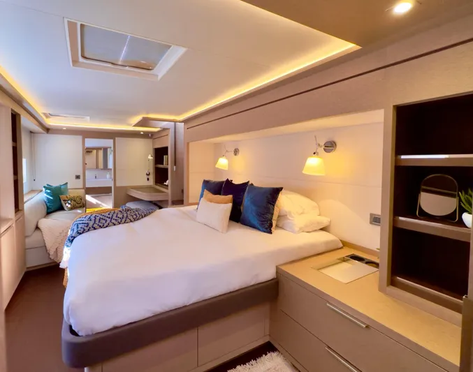 Twin Flame Yacht Photos Pics Luxurious bedroom interior of 2020 Lagoon Seventy 7 yacht with modern design and ambient lighting.