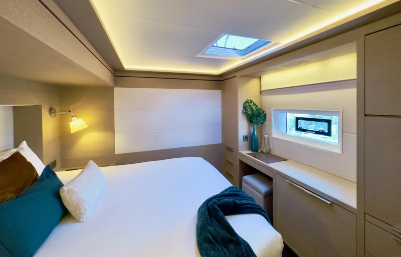 Twin Flame Yacht Photos Pics Luxurious cabin interior of 2020 Lagoon Seventy 7 yacht with modern decor and ambient lighting.