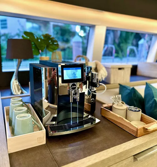 Twin Flame Yacht Photos Pics Luxurious coffee setup on Lagoon Seventy 7 yacht, featuring modern espresso machine and elegant decor.