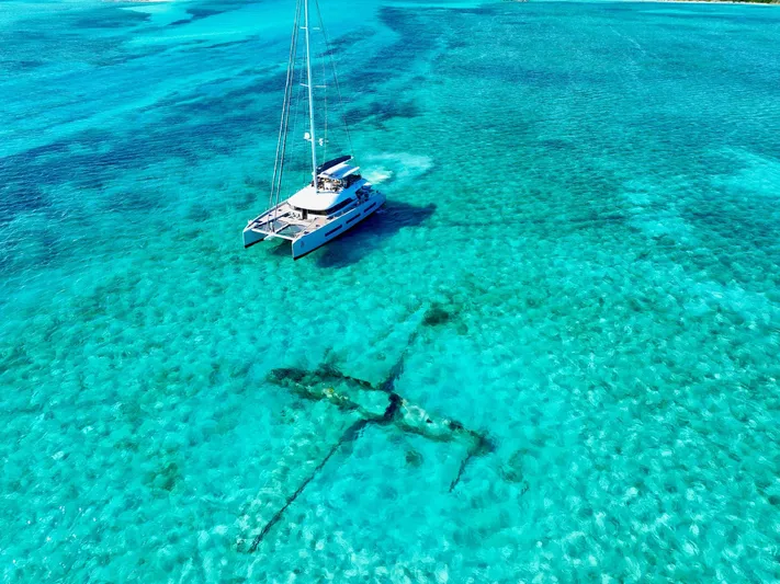 Twin Flame Yacht Photos Pics Lagoon Seventy 7 catamaran sailing in clear turquoise waters, 2020 model.