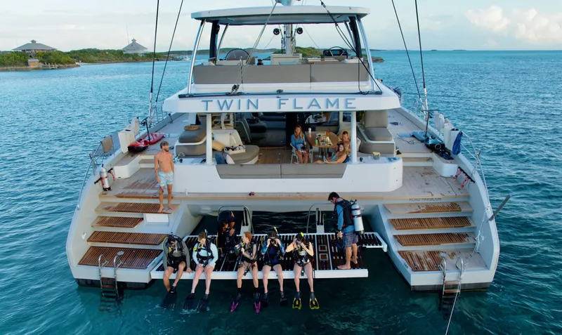 Twin Flame Yacht Photos Pics Luxury Lagoon Seventy 7 yacht "Twin Flame" with divers preparing to explore the ocean.