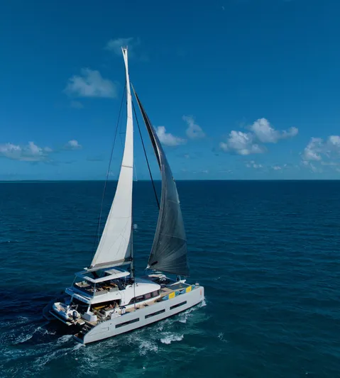 Twin Flame Yacht Photos Pics Luxury Lagoon Seventy 7 yacht sailing on open ocean under clear blue sky.