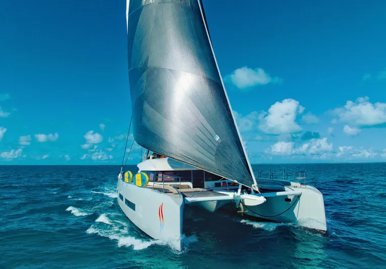 Twin Flame Yacht Photos Pics 2020 Lagoon Seventy 7 catamaran sailing on open ocean under clear blue sky.