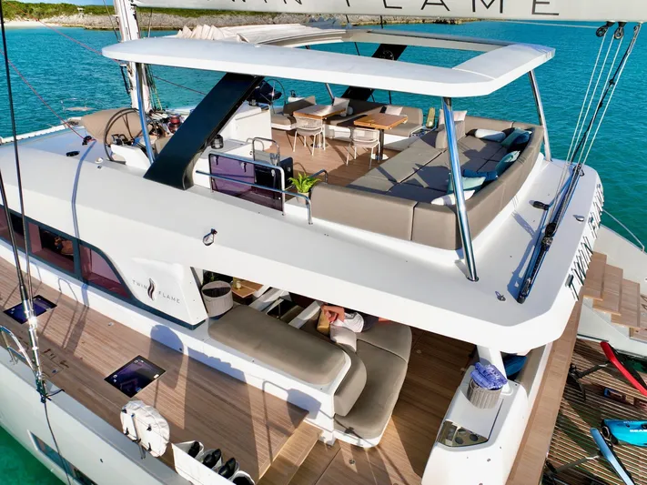 Twin Flame Yacht Photos Pics Luxurious 2020 Lagoon Seventy 7 yacht with spacious deck and seating area on turquoise waters.