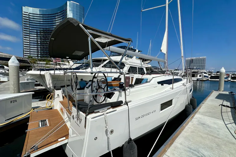Endless Summer Yacht Photos Pics 2024 Jeanneau Sun Odyssey 410 sailboat docked at marina, modern design, clear blue sky.