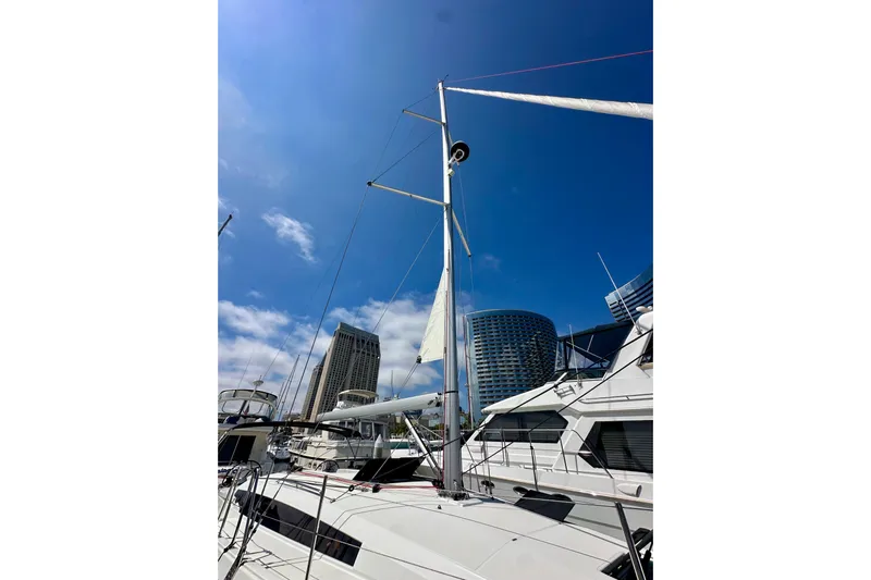 Endless Summer Yacht Photos Pics 2024 Jeanneau Sun Odyssey 410 sailboat docked with city skyline background.