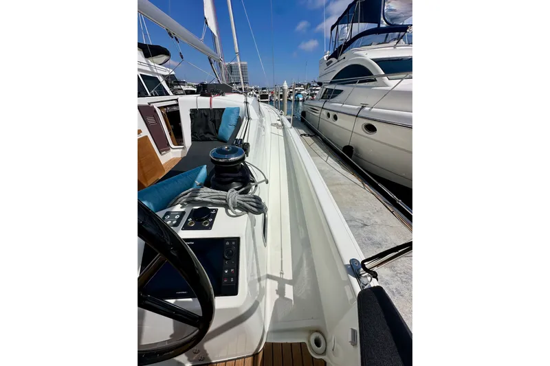 Endless Summer Yacht Photos Pics 2024 Jeanneau Sun Odyssey 410 sailboat docked, showcasing deck and steering wheel.