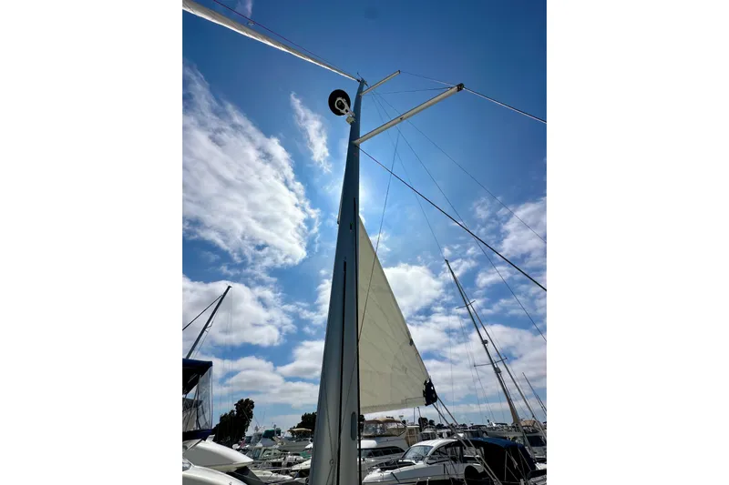 Endless Summer Yacht Photos Pics Sailboat mast and sail of 2024 Jeanneau Sun Odyssey 410 against a blue sky.
