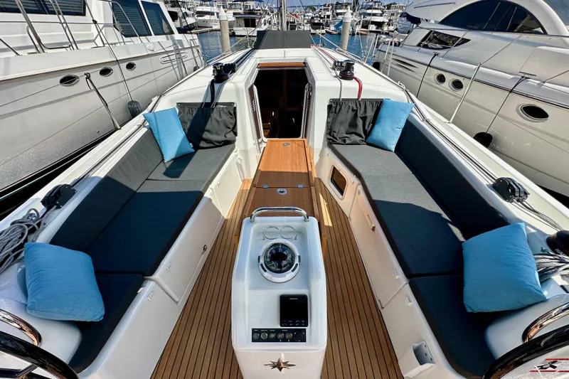 Endless Summer Yacht Photos Pics 2024 Jeanneau Sun Odyssey 410 yacht cockpit with cushioned seating and teak flooring.
