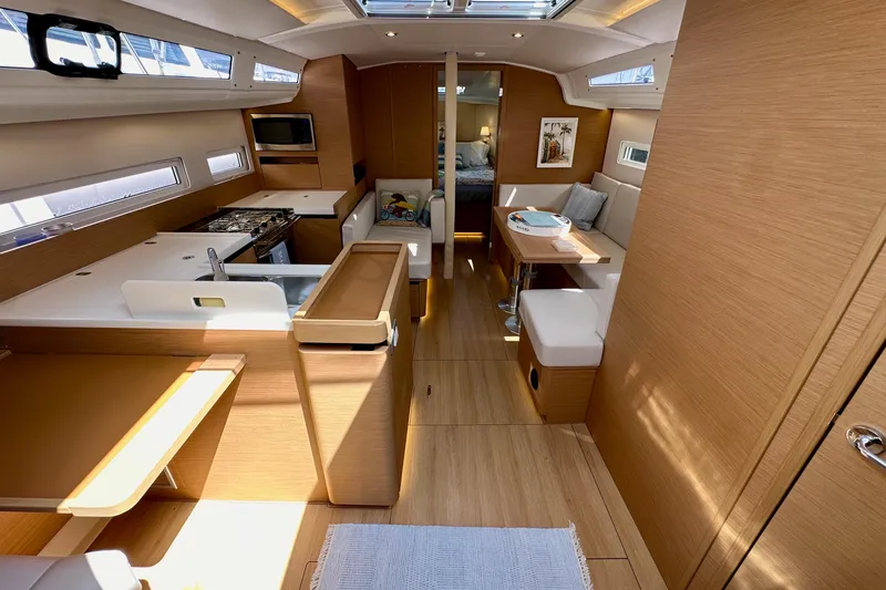 Endless Summer Yacht Photos Pics Interior of 2024 Jeanneau Sun Odyssey 410 sailboat, featuring modern wood finish and spacious layout.