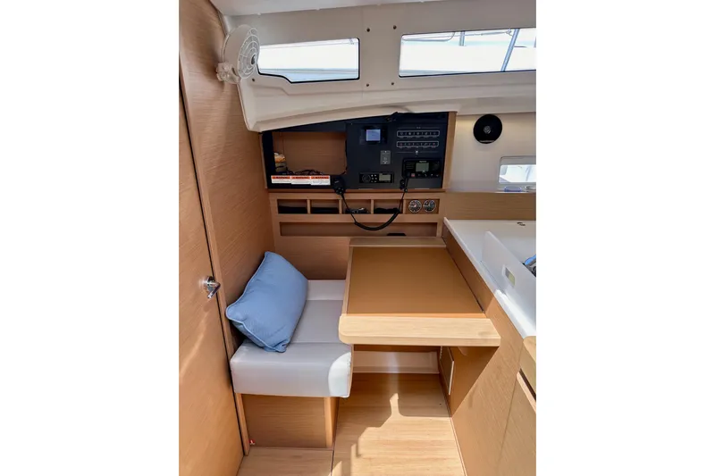 Endless Summer Yacht Photos Pics Interior of 2024 Jeanneau Sun Odyssey 410 sailboat with navigation station and seating area.