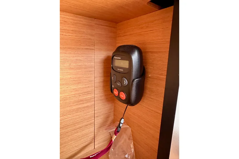 Endless Summer Yacht Photos Pics Control panel inside 2024 Jeanneau Sun Odyssey 410 yacht, mounted on wooden interior.