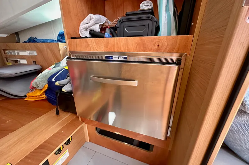 Endless Summer Yacht Photos Pics Interior of 2024 Jeanneau Sun Odyssey 410 with stainless steel appliance and storage.