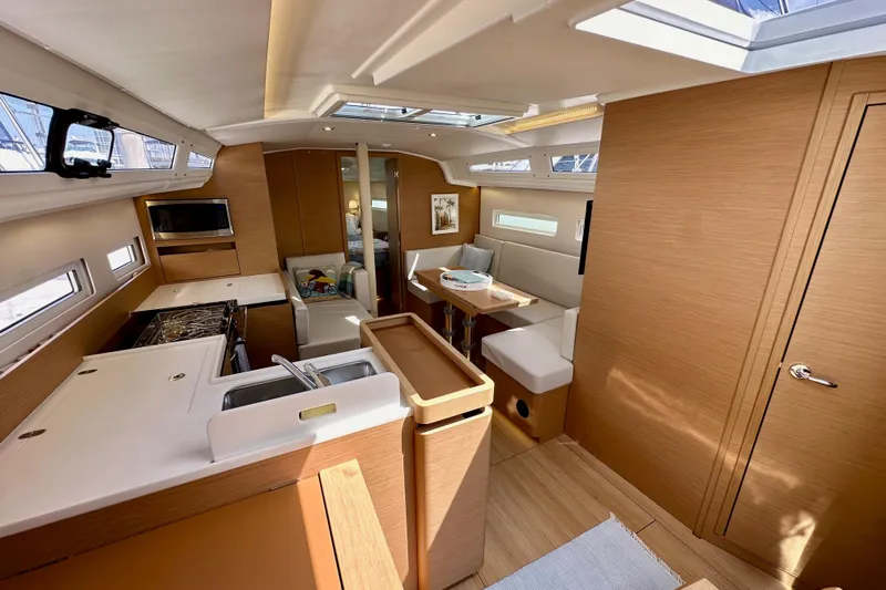 Endless Summer Yacht Photos Pics Interior of 2024 Jeanneau Sun Odyssey 410 yacht, featuring modern kitchen and seating area.