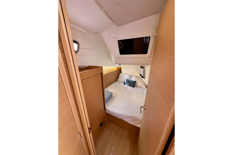 Endless Summer Yacht Photos Pics Cozy cabin interior of 2024 Jeanneau Sun Odyssey 410 sailboat, featuring a comfortable bed.