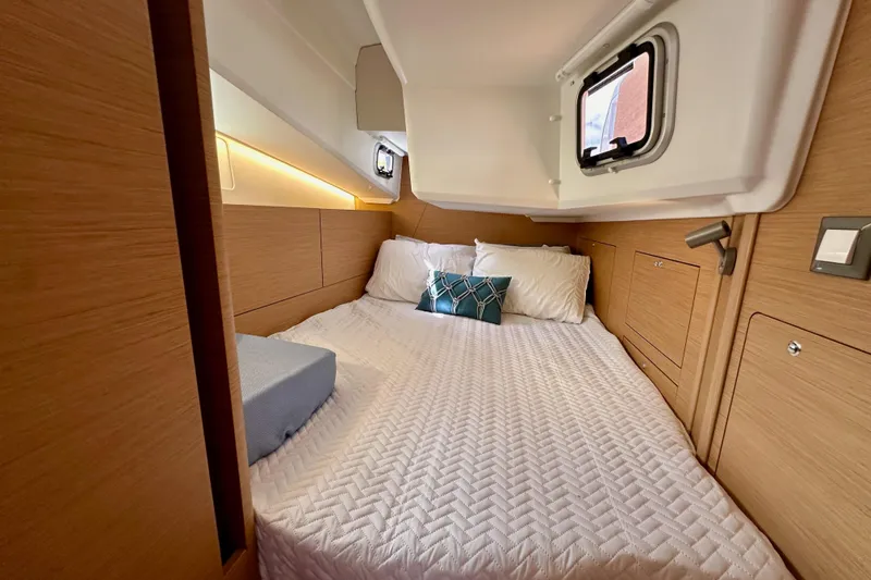 Endless Summer Yacht Photos Pics 2024 Jeanneau Sun Odyssey 410 cabin interior with cozy bed and modern design.