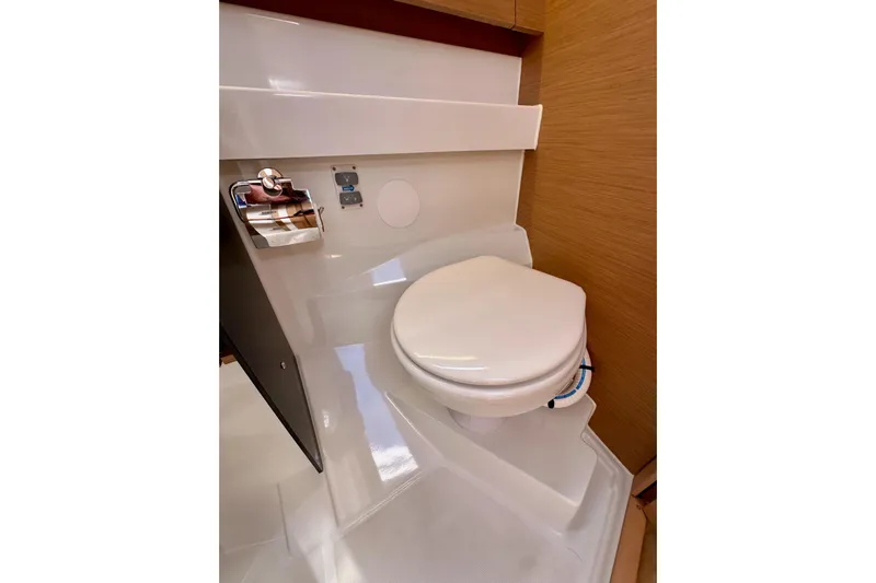 Endless Summer Yacht Photos Pics 2024 Jeanneau Sun Odyssey 410 yacht bathroom with modern toilet and wooden accents.