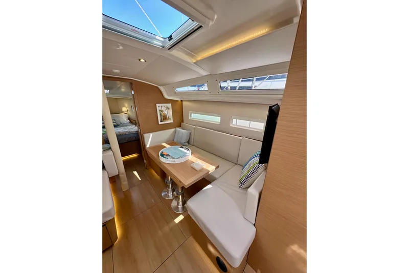 Endless Summer Yacht Photos Pics Interior of 2024 Jeanneau Sun Odyssey 410 yacht, featuring modern seating and natural light.