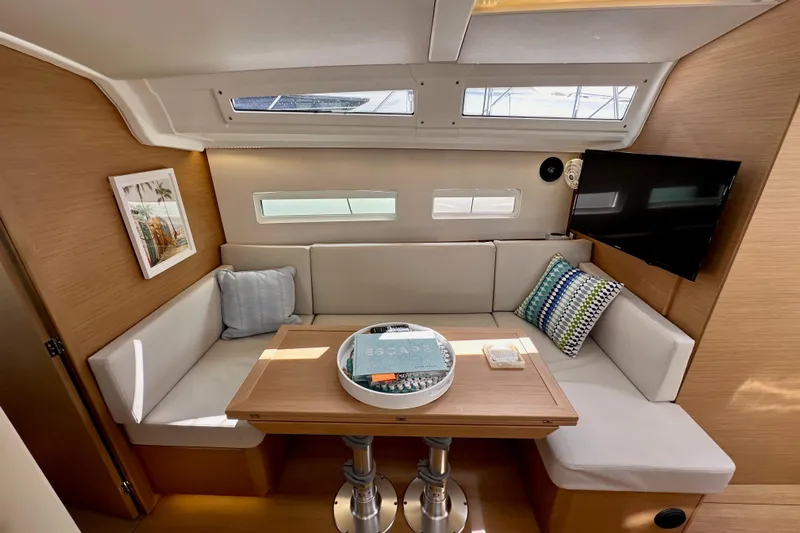 Endless Summer Yacht Photos Pics 2024 Jeanneau Sun Odyssey 410 interior with cozy seating, table, and modern decor.
