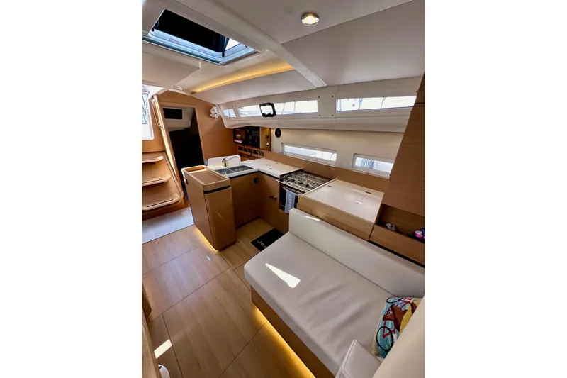 Endless Summer Yacht Photos Pics Interior of 2024 Jeanneau Sun Odyssey 410 yacht, featuring modern kitchen and seating area.