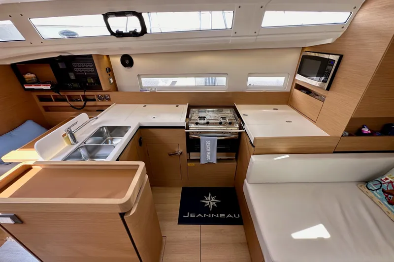 Endless Summer Yacht Photos Pics Interior of 2024 Jeanneau Sun Odyssey 410 yacht, featuring modern kitchen and seating area.