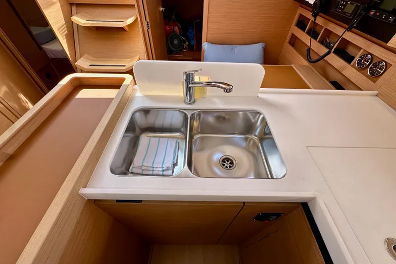 Endless Summer Yacht Photos Pics 2024 Jeanneau Sun Odyssey 410 yacht kitchen with dual sink and modern wood cabinetry.