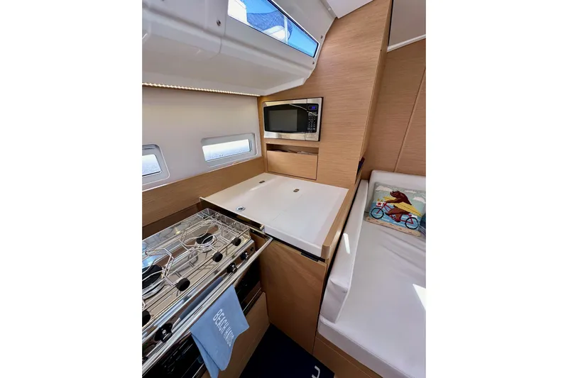 Endless Summer Yacht Photos Pics 2024 Jeanneau Sun Odyssey 410 interior with modern kitchen and cozy seating area.