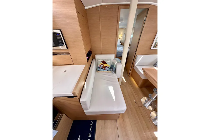 Endless Summer Yacht Photos Pics Interior of 2024 Jeanneau Sun Odyssey 410 yacht, featuring modern wood finish and cozy seating.