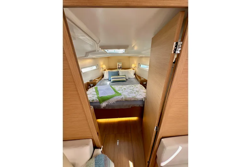 Endless Summer Yacht Photos Pics Cozy cabin interior of 2024 Jeanneau Sun Odyssey 410 sailboat, featuring a comfortable bed.