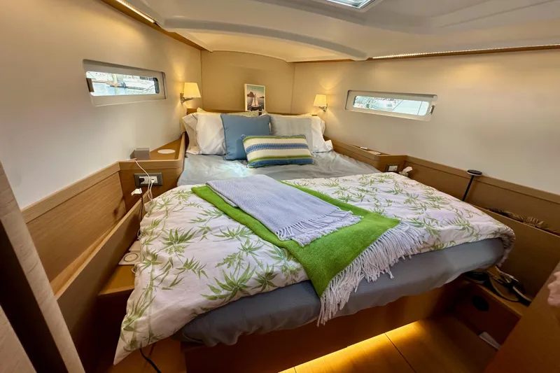 Endless Summer Yacht Photos Pics Luxurious cabin interior of 2024 Jeanneau Sun Odyssey 410 sailboat, featuring cozy bedding.
