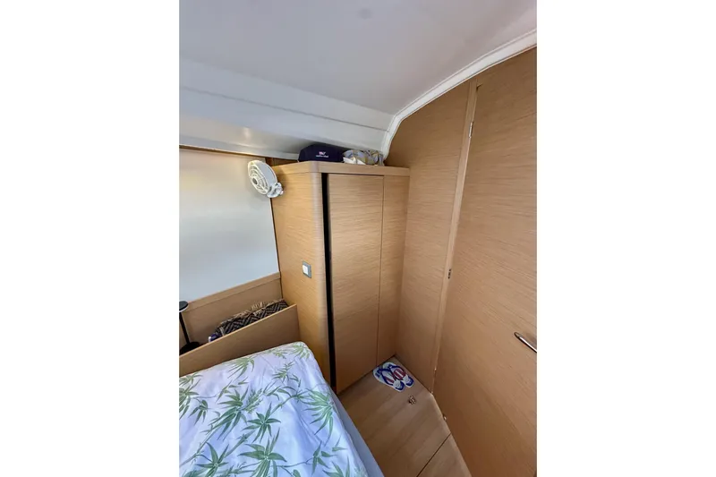 Endless Summer Yacht Photos Pics 2024 Jeanneau Sun Odyssey 410 cabin interior with wooden cabinetry and bed.