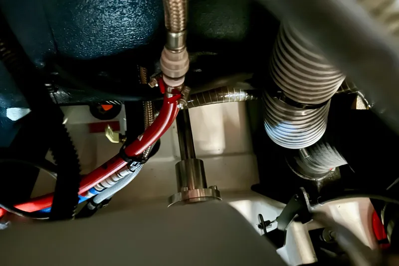 Endless Summer Yacht Photos Pics Engine compartment of 2024 Jeanneau Sun Odyssey 410 sailboat, showing hoses and wiring.