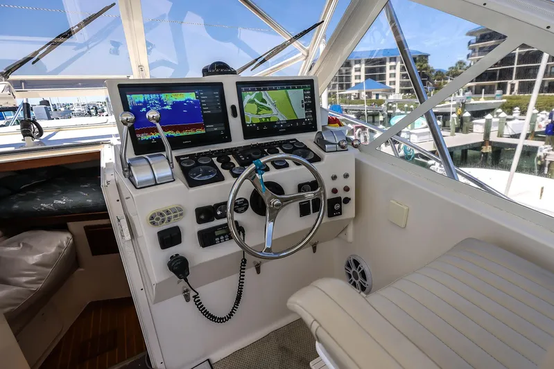 Patriot Yacht Photos Pics 2005 Carolina Classic 32 boat cockpit with navigation screens and steering wheel.