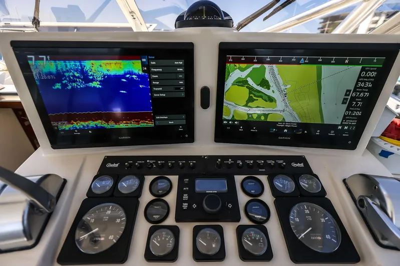 Patriot Yacht Photos Pics Control panel of a 2005 Carolina Classic 32 boat with navigation screens and gauges.