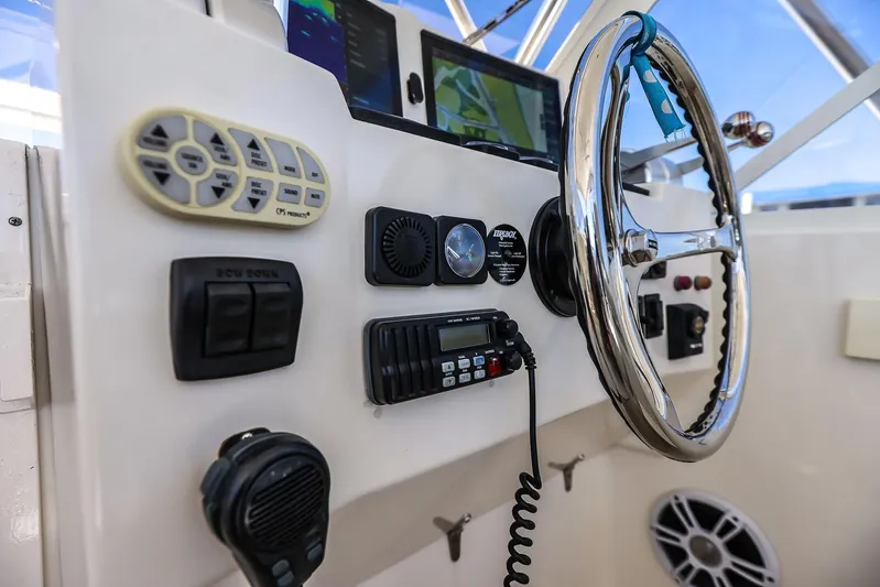 Patriot Yacht Photos Pics Control panel of a 2005 Carolina Classic 32 boat with steering wheel and navigation equipment.