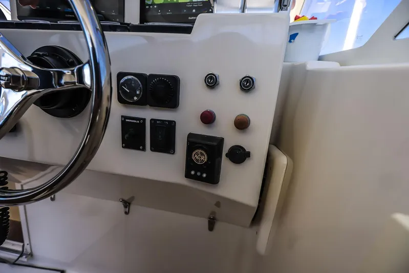 Patriot Yacht Photos Pics Control panel of a 2005 Carolina Classic 32 boat with steering wheel and gauges.